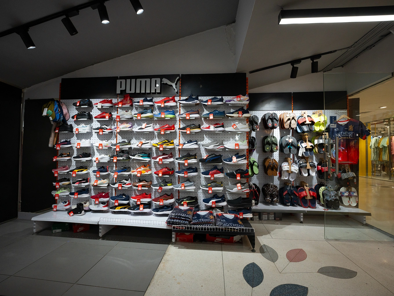 VA Sports interior with footwear and backpacks at Kapali Mall, Bengaluru